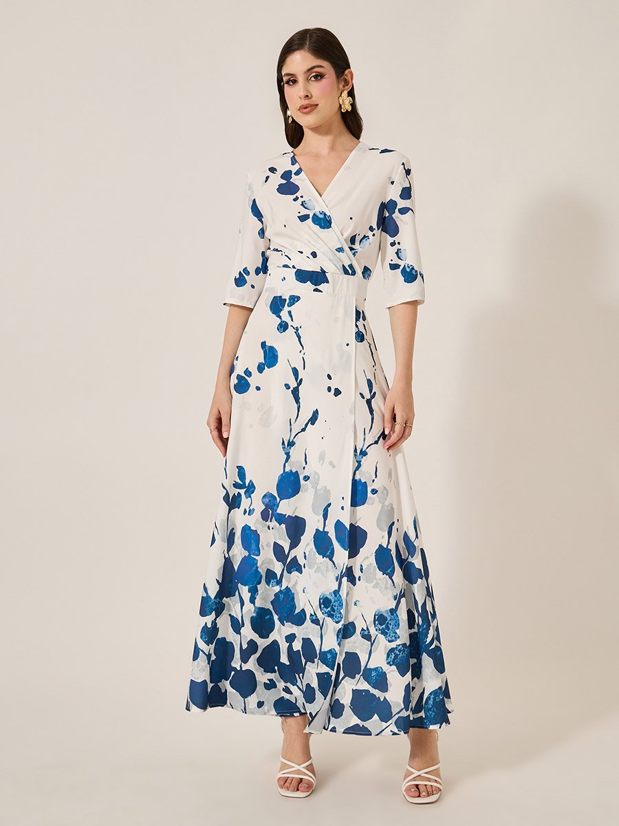 Elegant women's dress with blue floral print, featuring a wrap design and three-quarter sleeves, perfect for summer.
