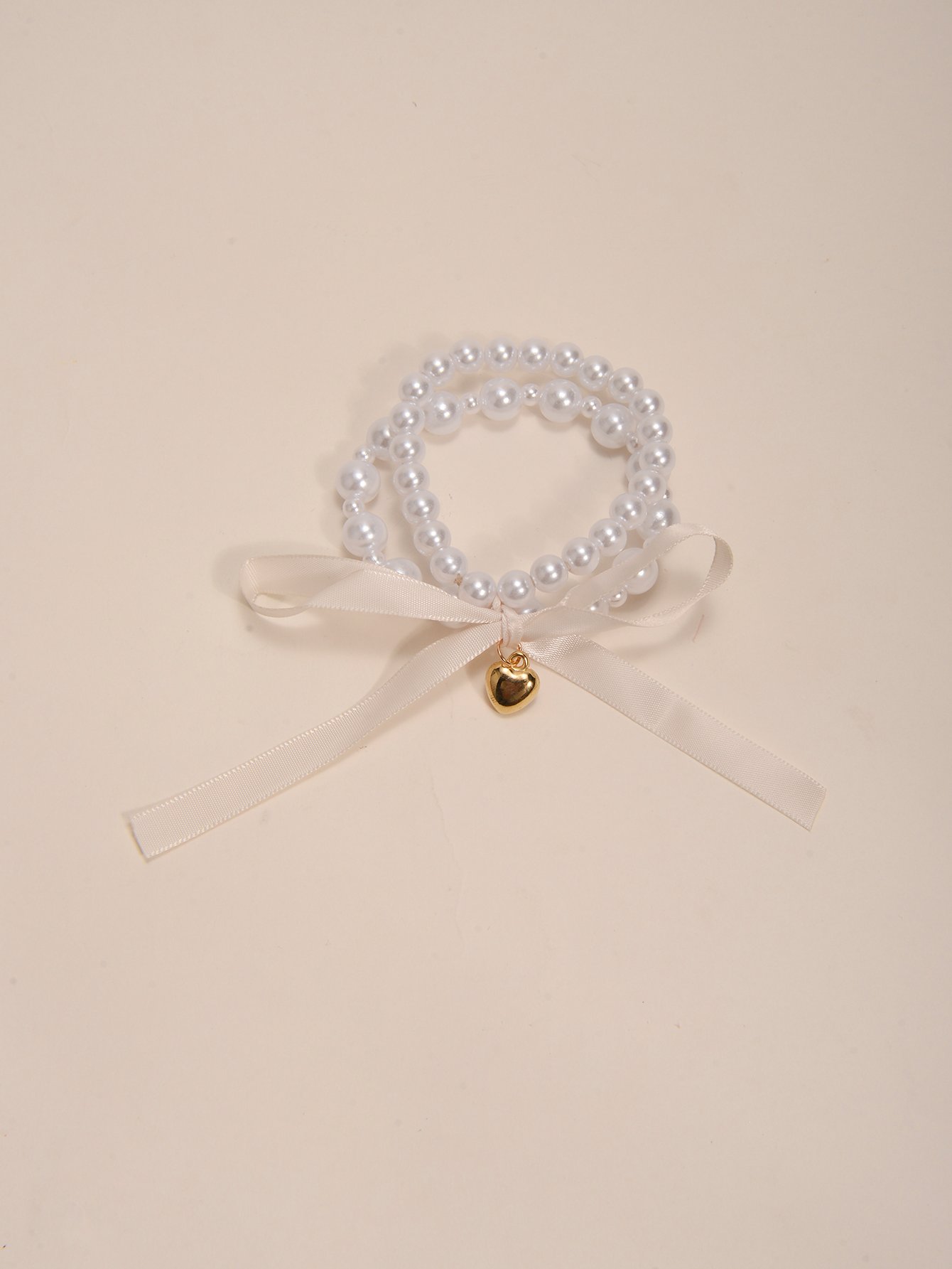 Multistrand Faux Pearl Bracelet with Heart and Bow Charms