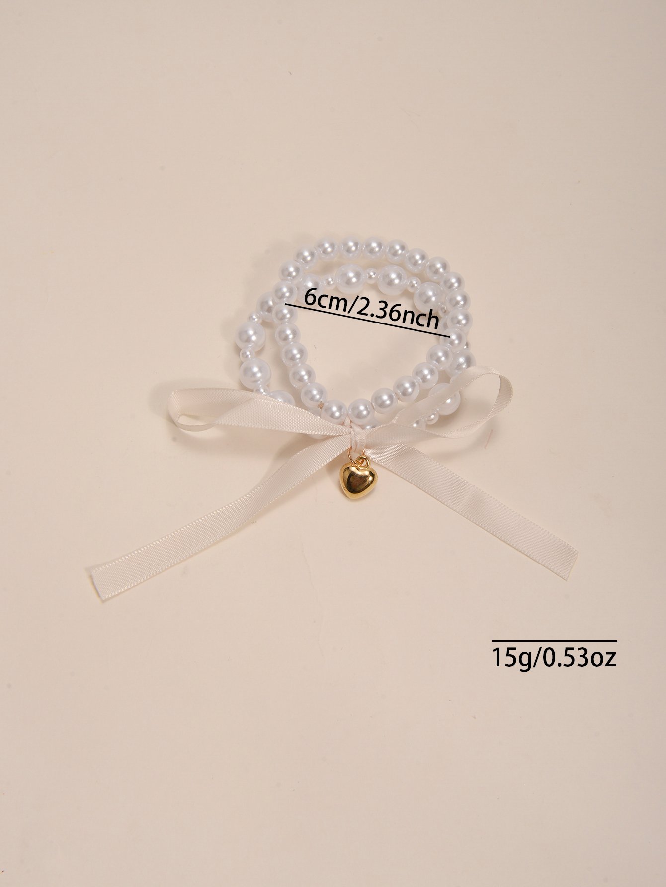 Multistrand Faux Pearl Bracelet with Heart and Bow Charms
