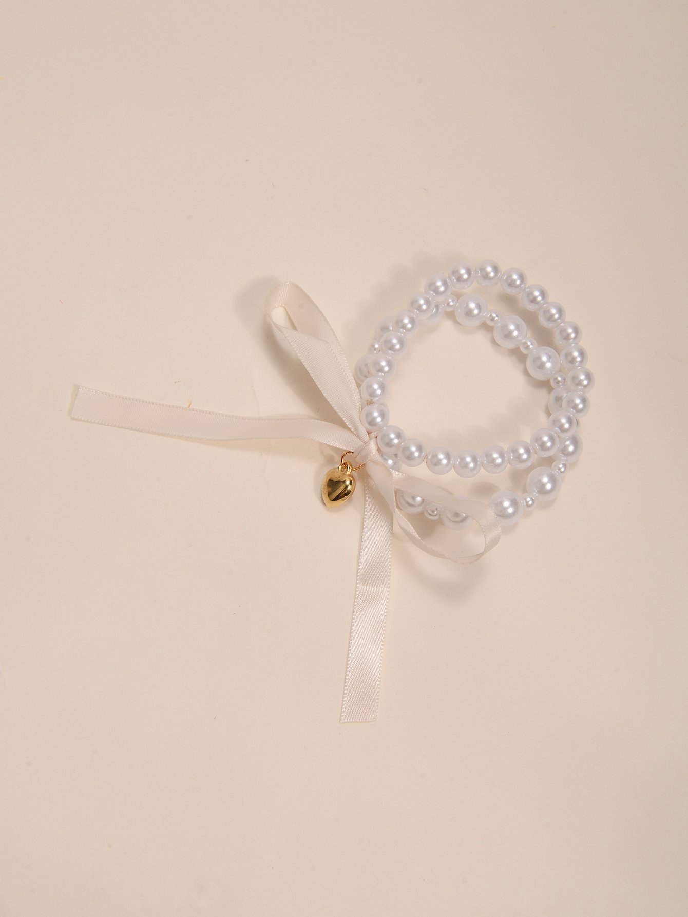 Multistrand Faux Pearl Bracelet with Heart and Bow Charms