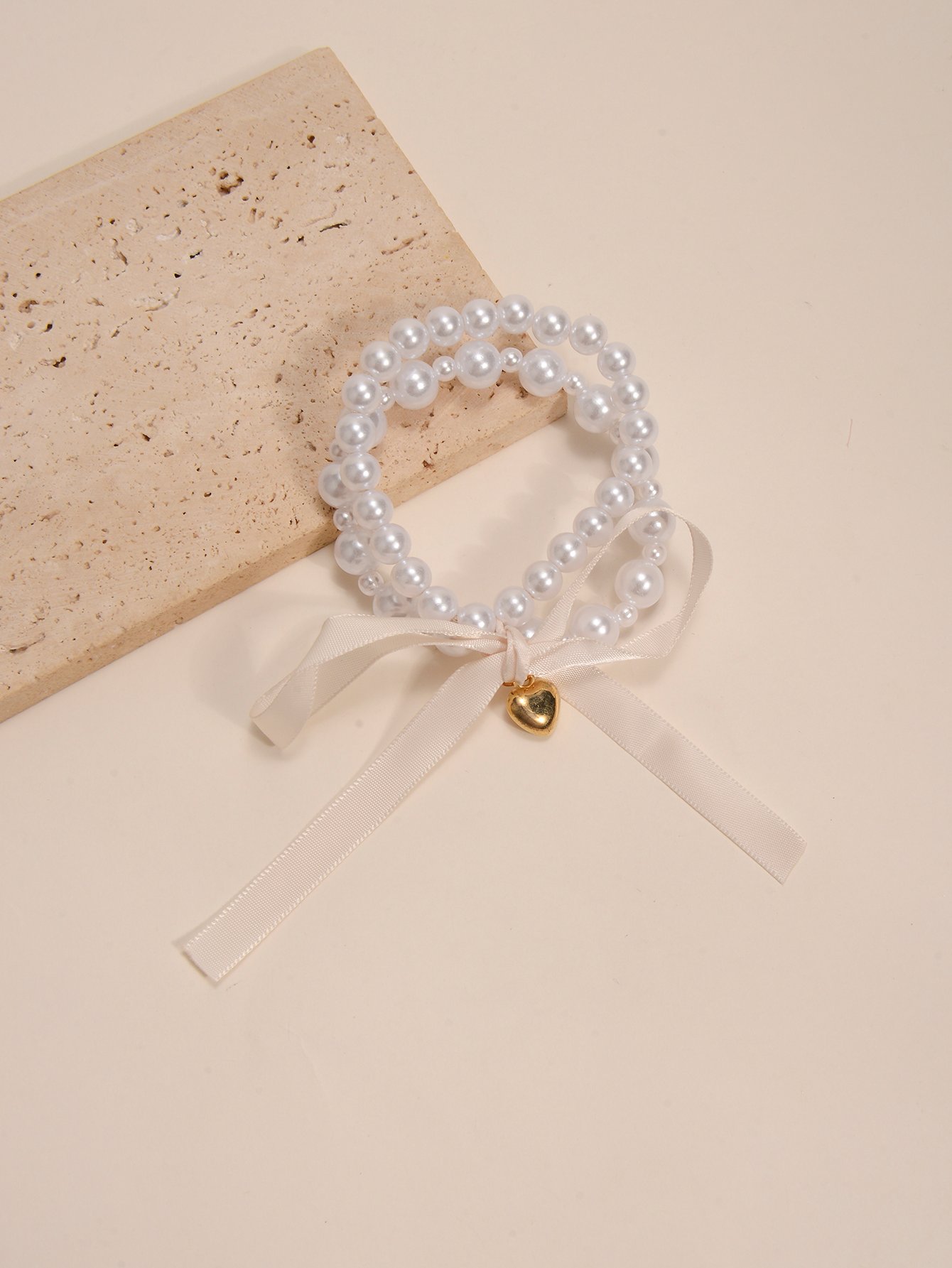 Multistrand Faux Pearl Bracelet with Heart and Bow Charms