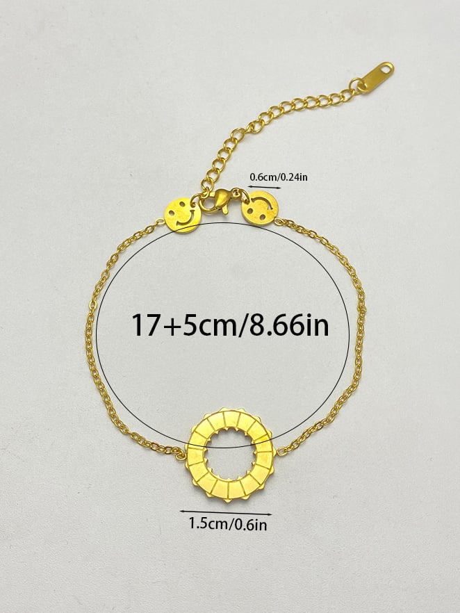Golden Charm Bracelet with Smiley Faces and Rotating Ring, Adjustable for Casual Wear.