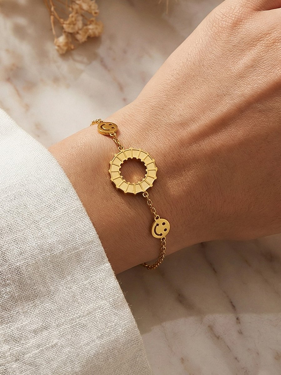 Golden Charm Bracelet with Smiley Faces and Rotating Ring, Adjustable for Casual Wear.