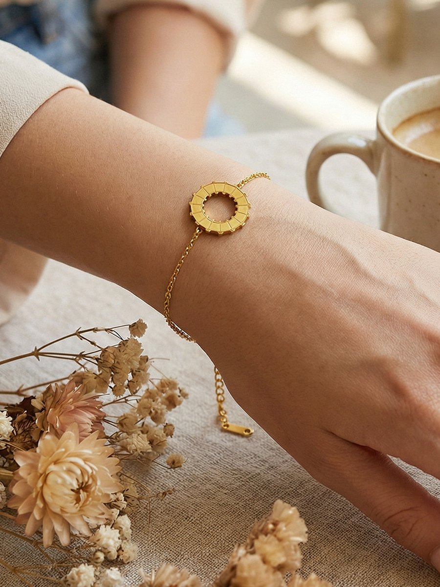Golden Charm Bracelet with Smiley Faces and Rotating Ring, Adjustable for Casual Wear.