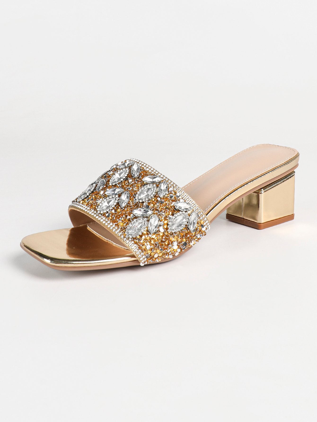 Sparkling gold mid-heel sandals, adorned with dazzling embellishments.