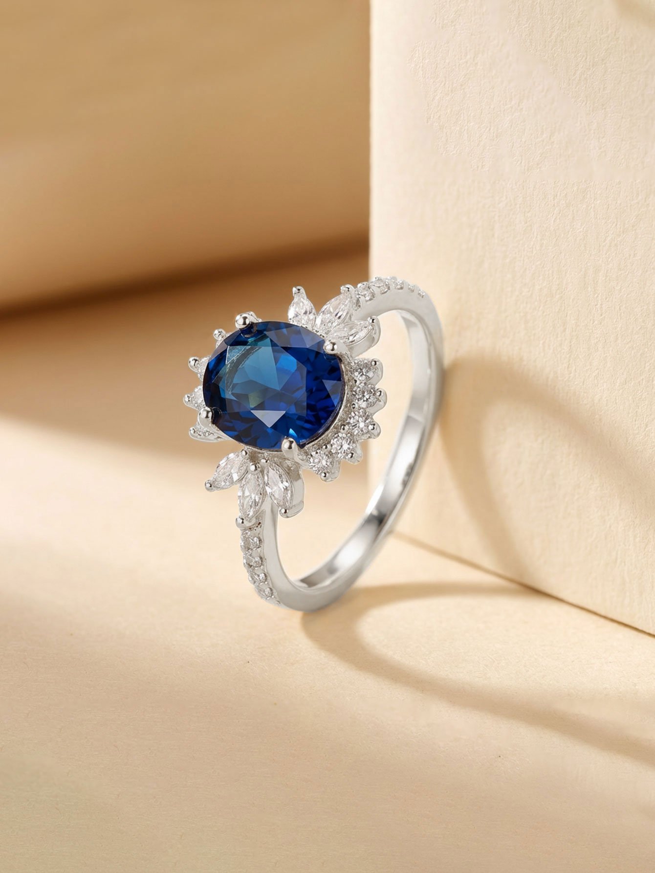 Silver Plated Oval Blue Zircon Ring with Floral CZ Accent