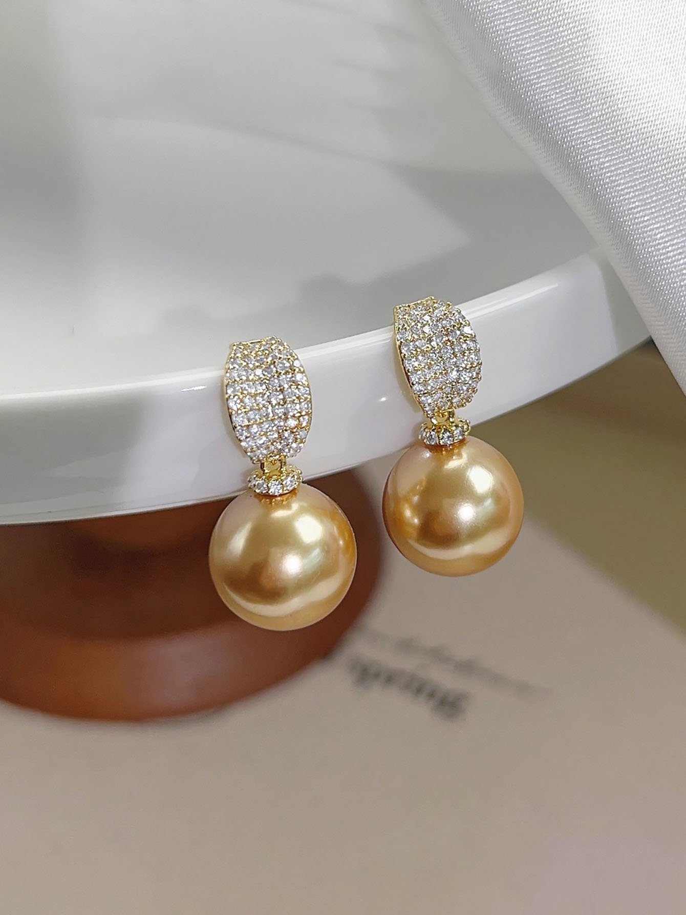 Golden Pearl Stud Earrings with Zircon Accent.