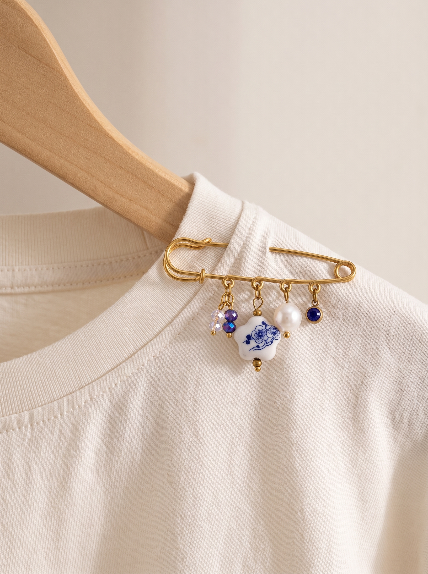 Elegant Gold Plated Brooch with Blue and White Porcelain Charm