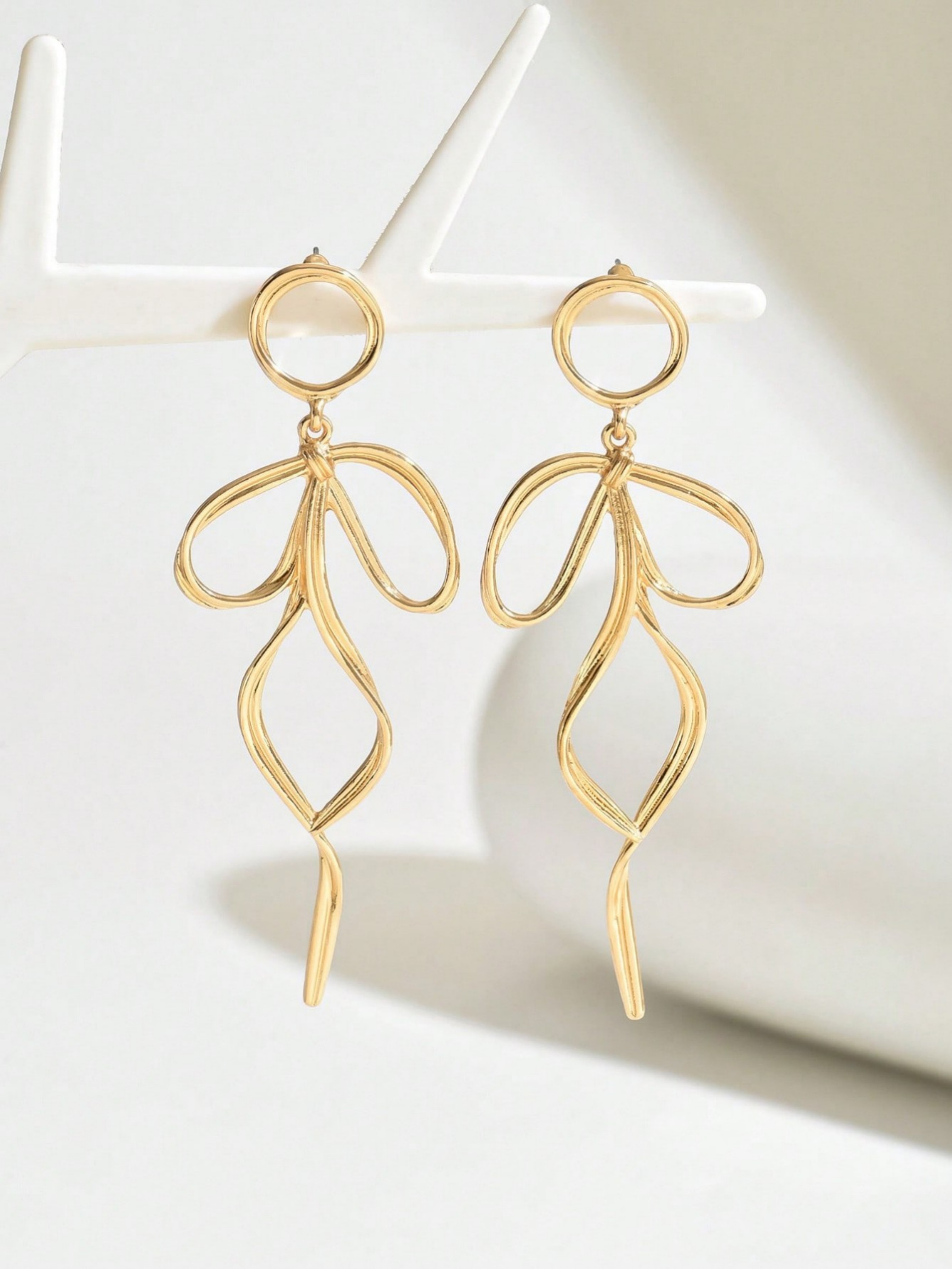 Gold Dangle Earrings with Bow Design