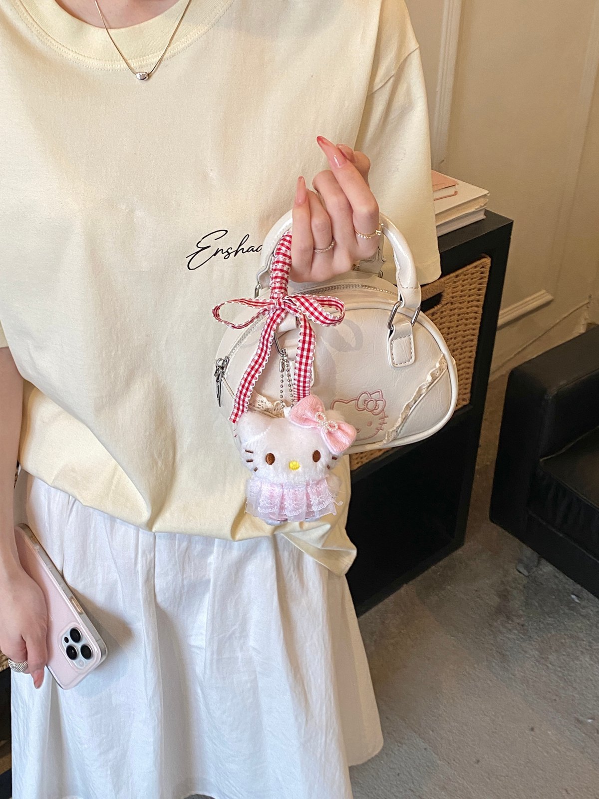 Off-White Handbag with Decorative Ribbon and Charm