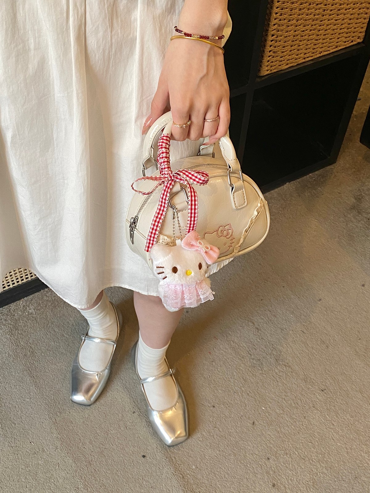 Off-White Handbag with Decorative Ribbon and Charm