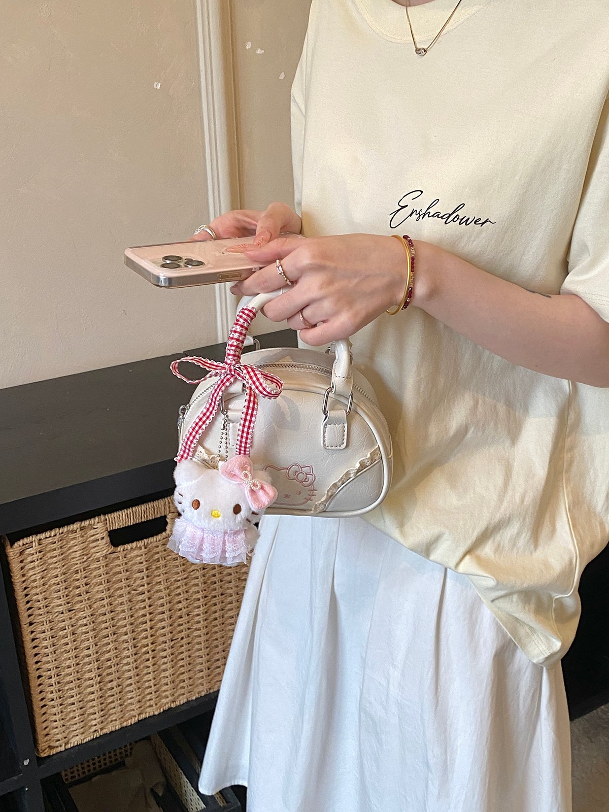Off-White Handbag with Decorative Ribbon and Charm