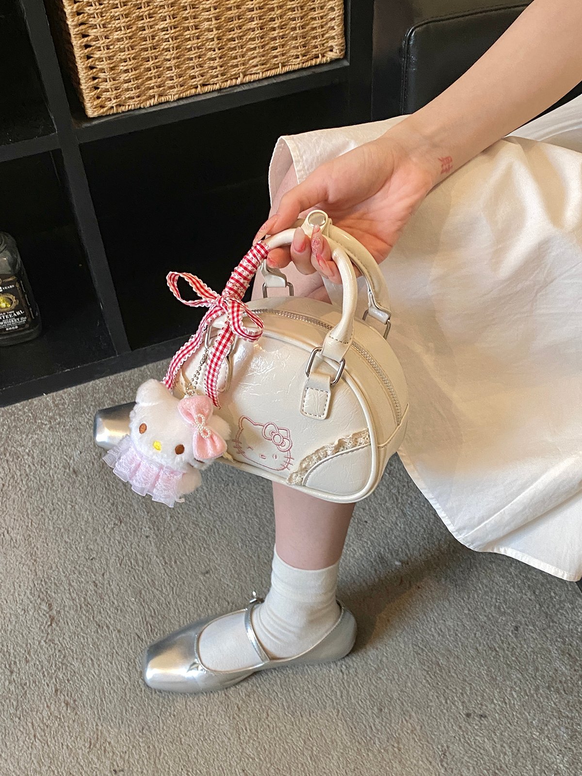 Off-White Handbag with Decorative Ribbon and Charm