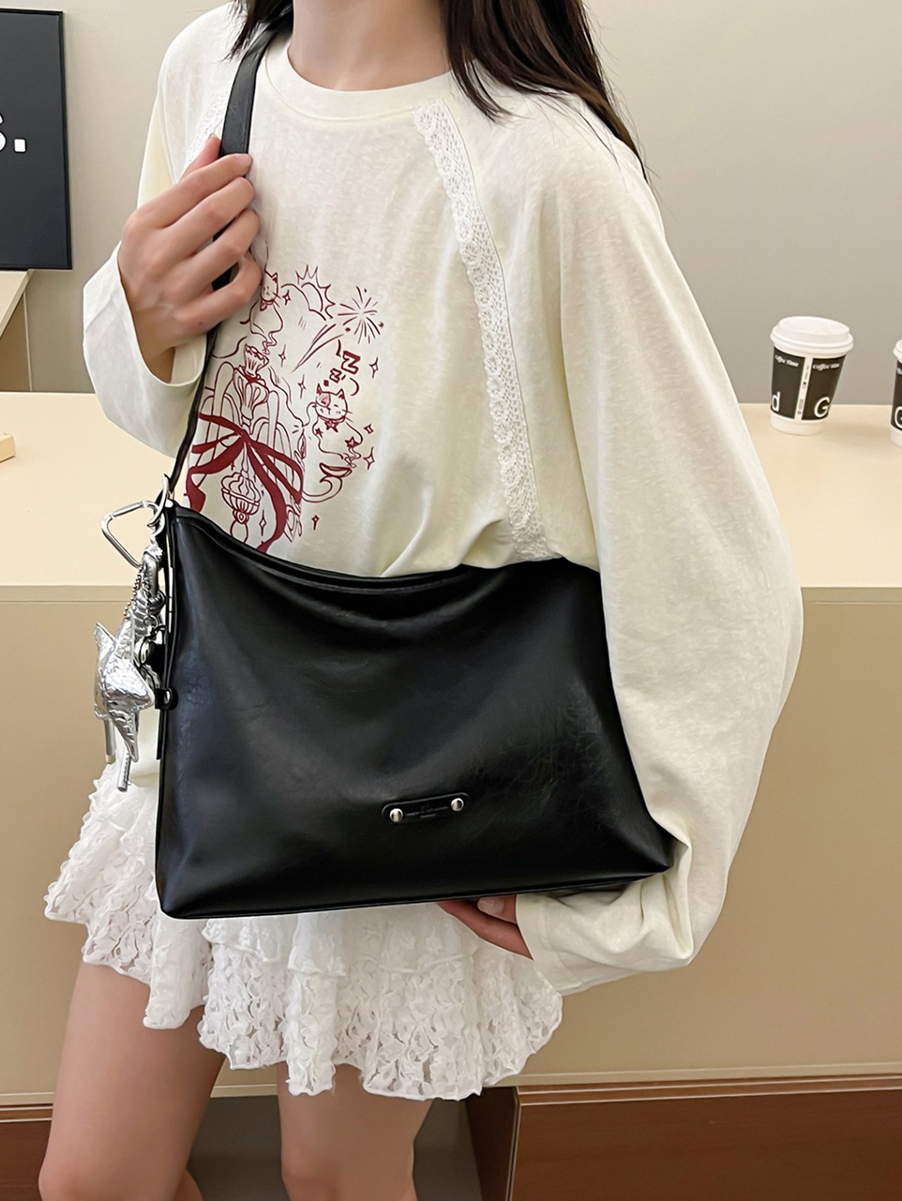 Black Crossbody Bag with Charm Detail