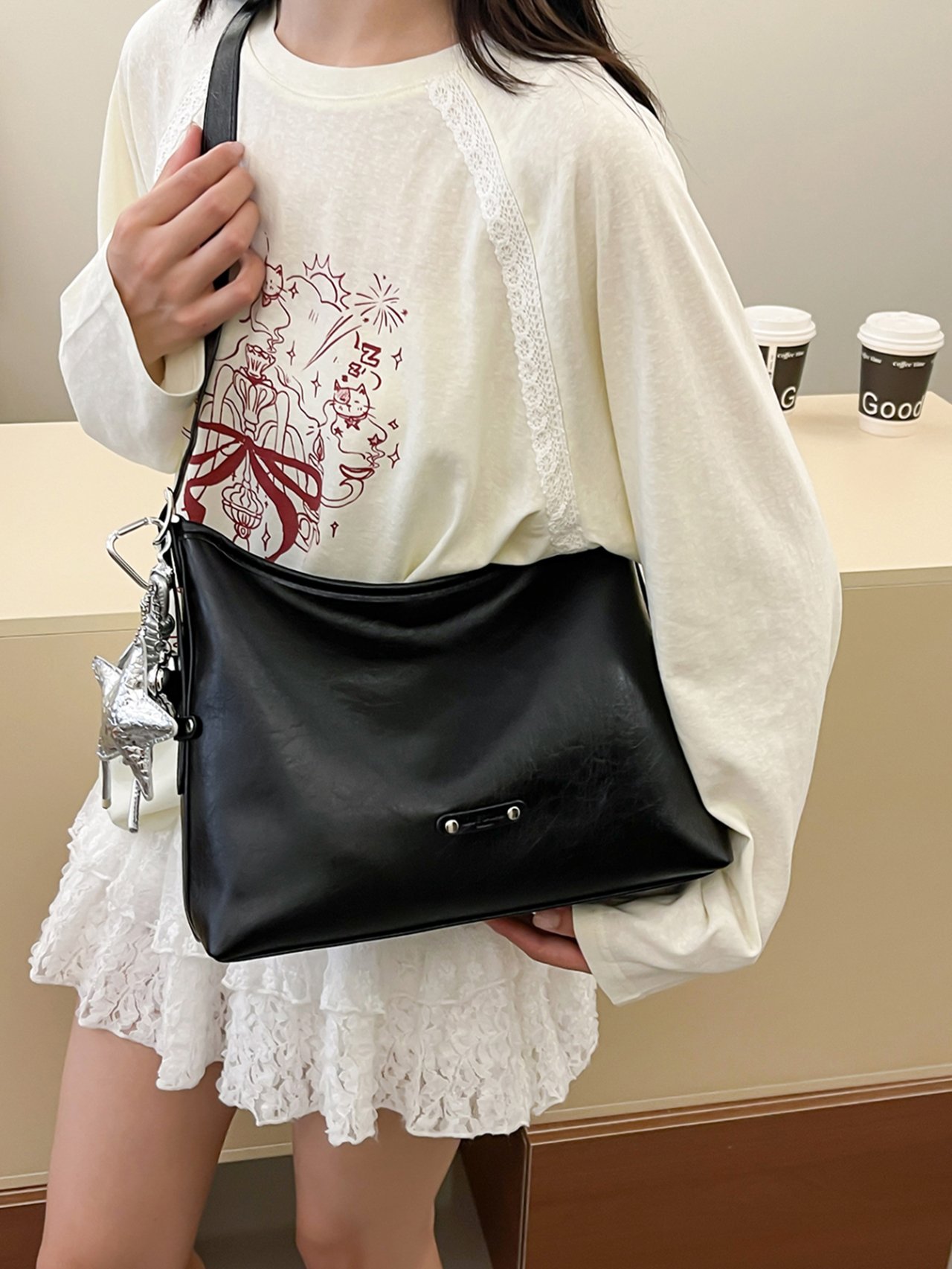 Black Crossbody Bag with Charm Detail