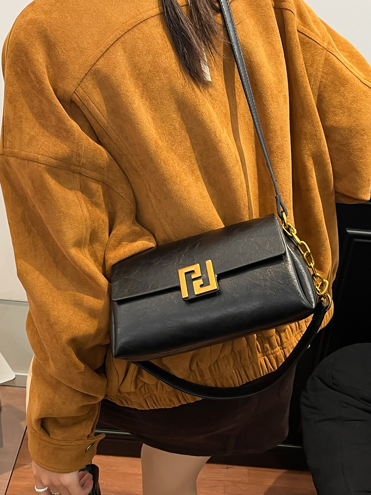 Black Crossbody Bag with Gold Chain Detail