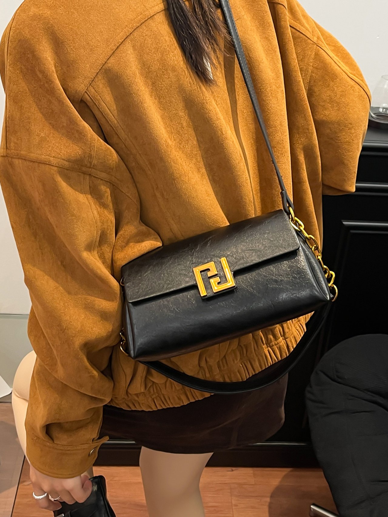 Black Crossbody Bag with Gold Chain Detail