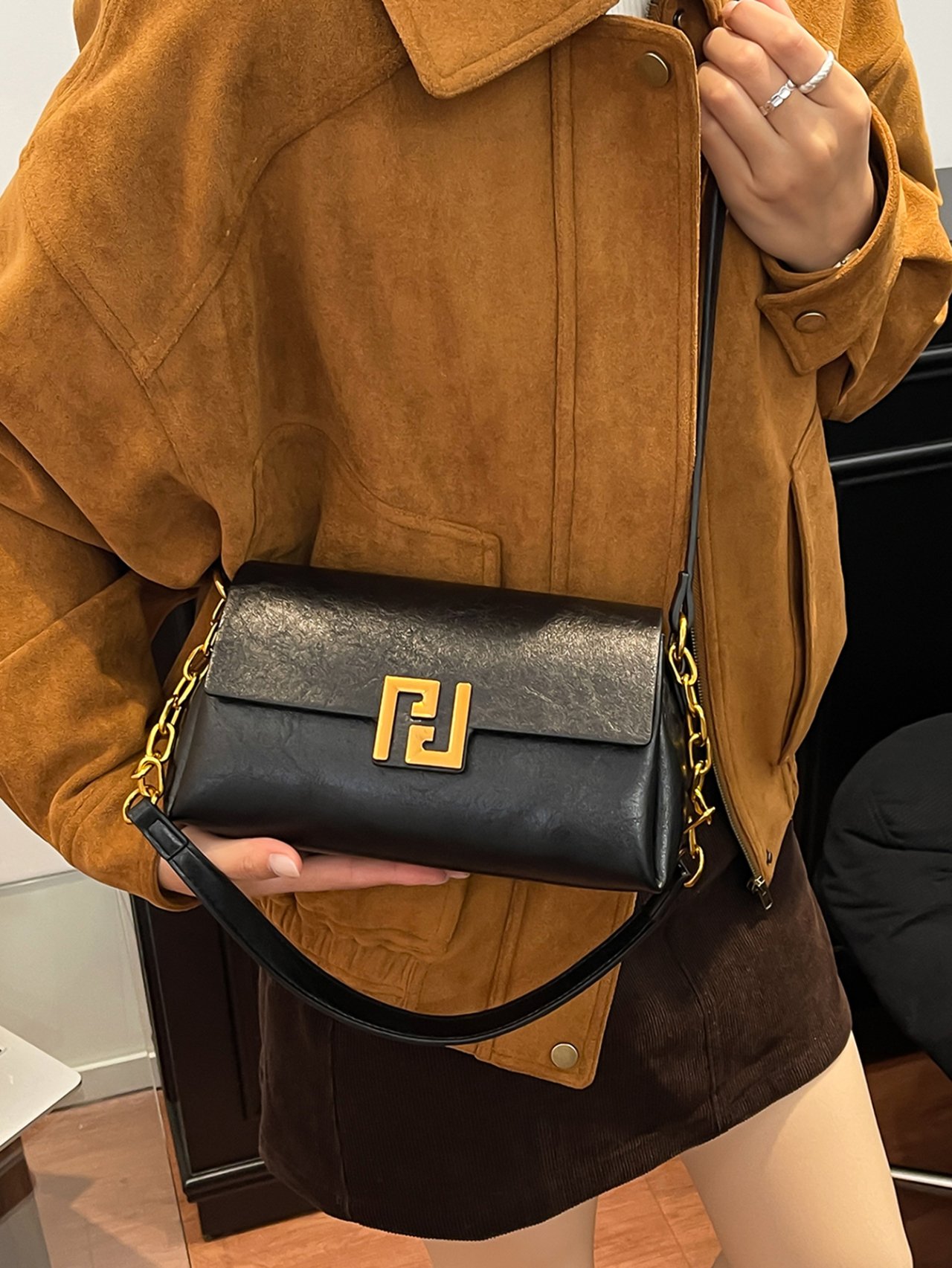 Black Crossbody Bag with Gold Chain Detail