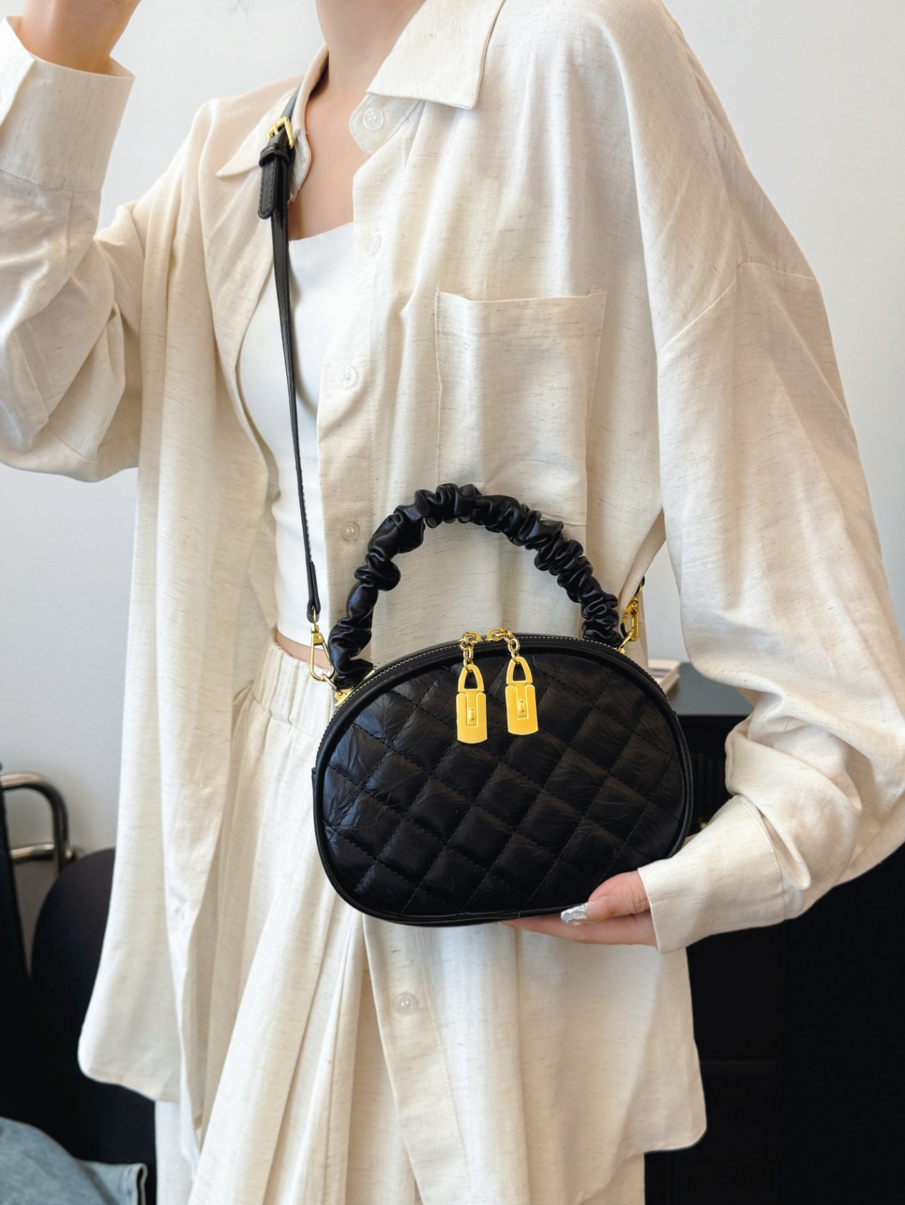 Black Quilted Crossbody Bag with Gold Accents