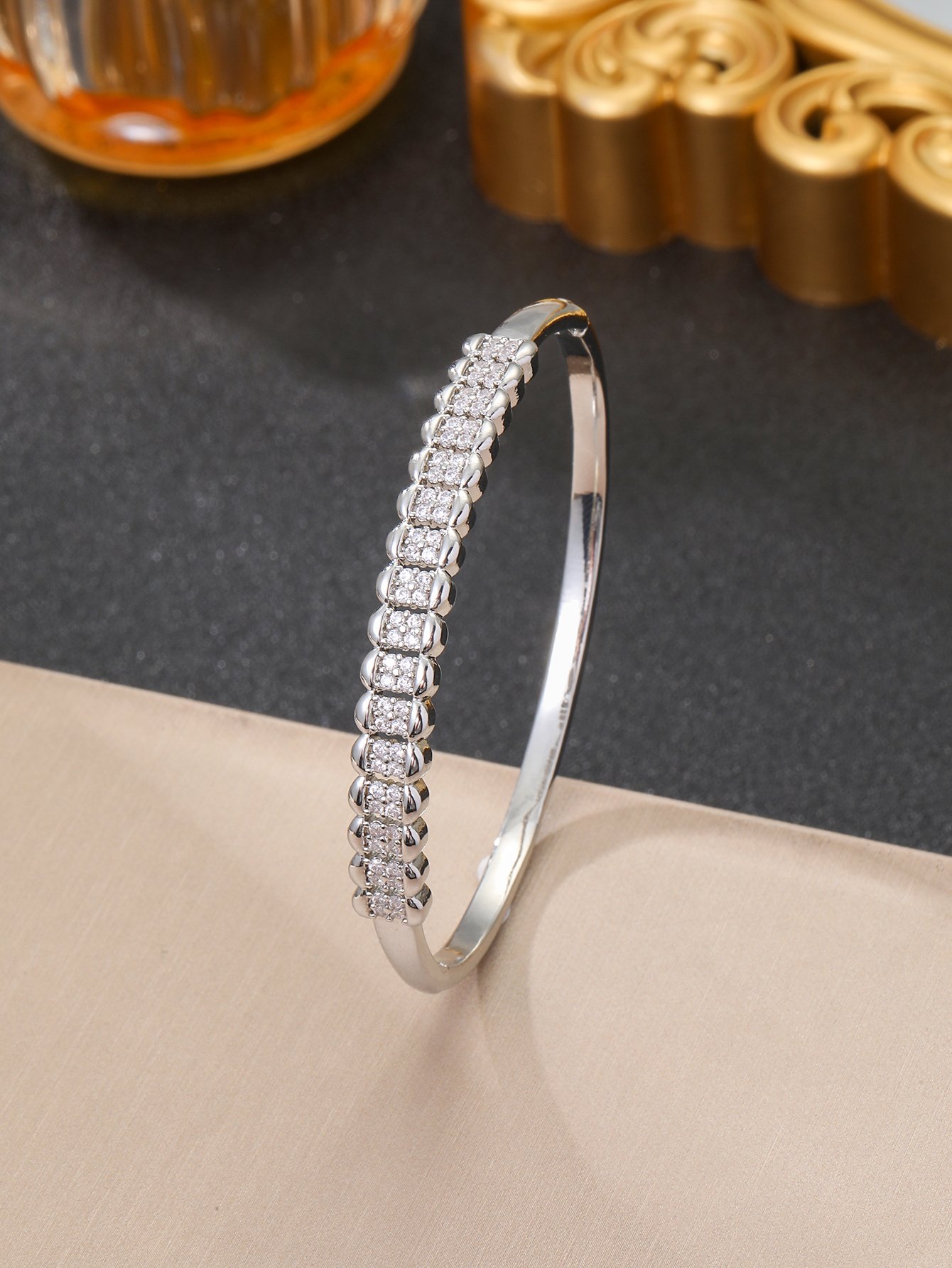 A silver honeycomb-shaped bracelet set with ultra-shiny cubic zirconia, perfect for parties and dinners
