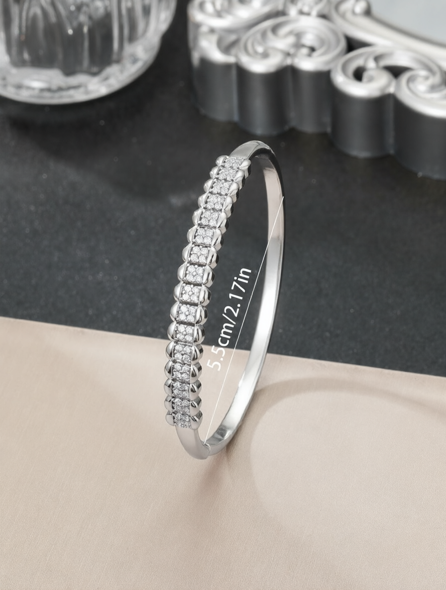 A silver honeycomb-shaped bracelet set with ultra-shiny cubic zirconia, perfect for parties and dinners