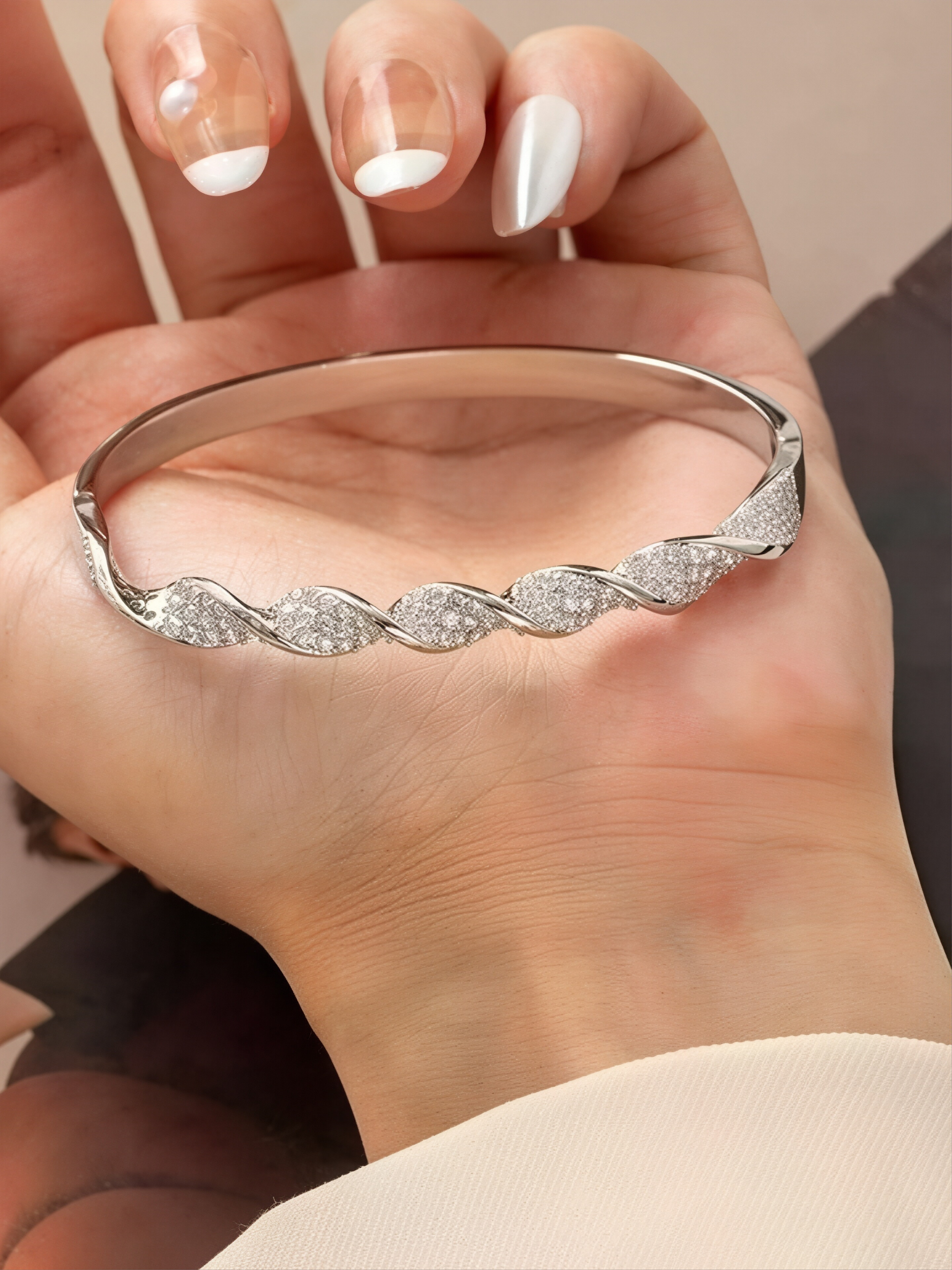 A silver twisted design ladies bracelet set with ultra-shiny cubic zirconia, perfect for parties and dinners