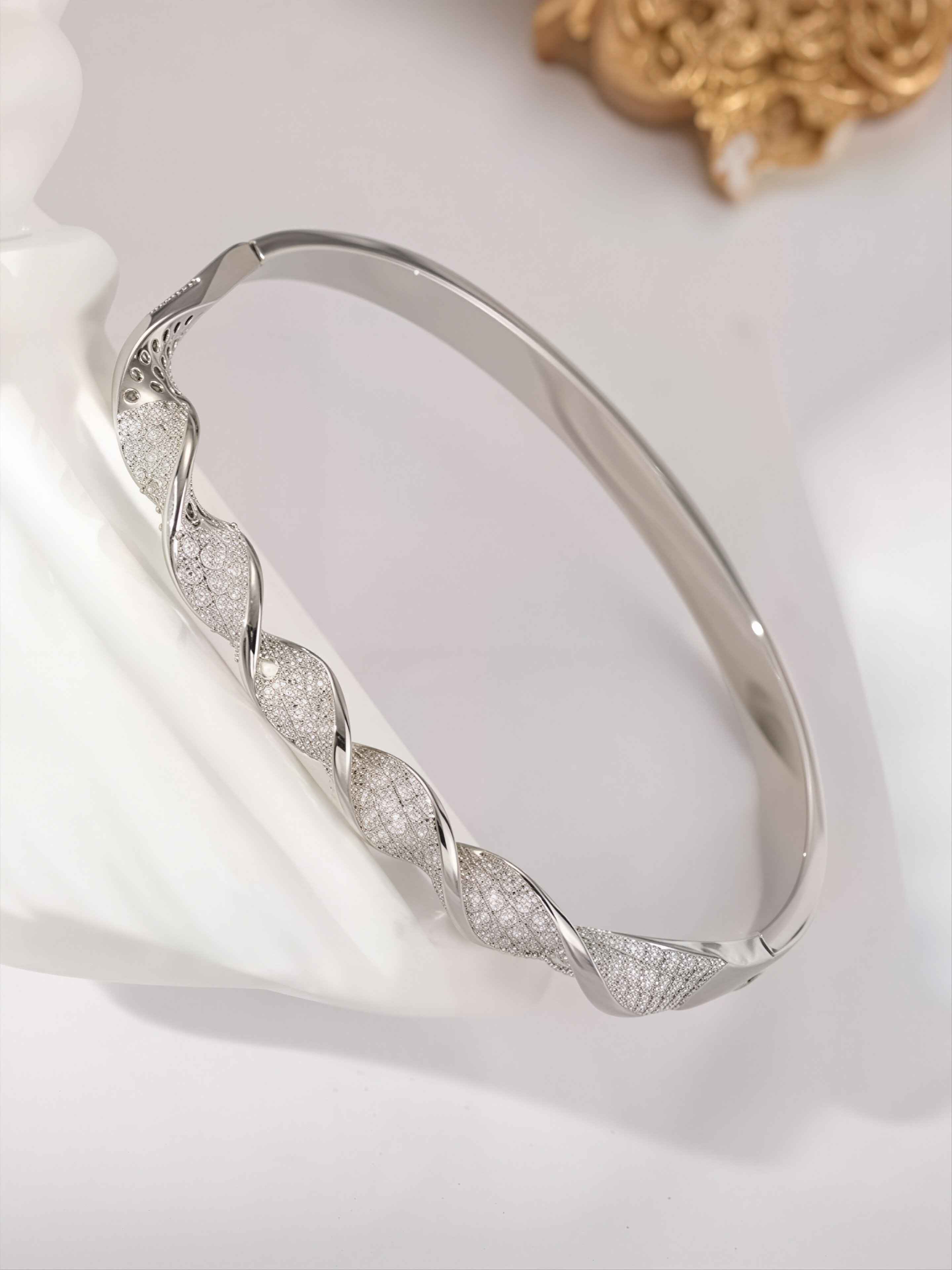 A silver twisted design ladies bracelet set with ultra-shiny cubic zirconia, perfect for parties and dinners