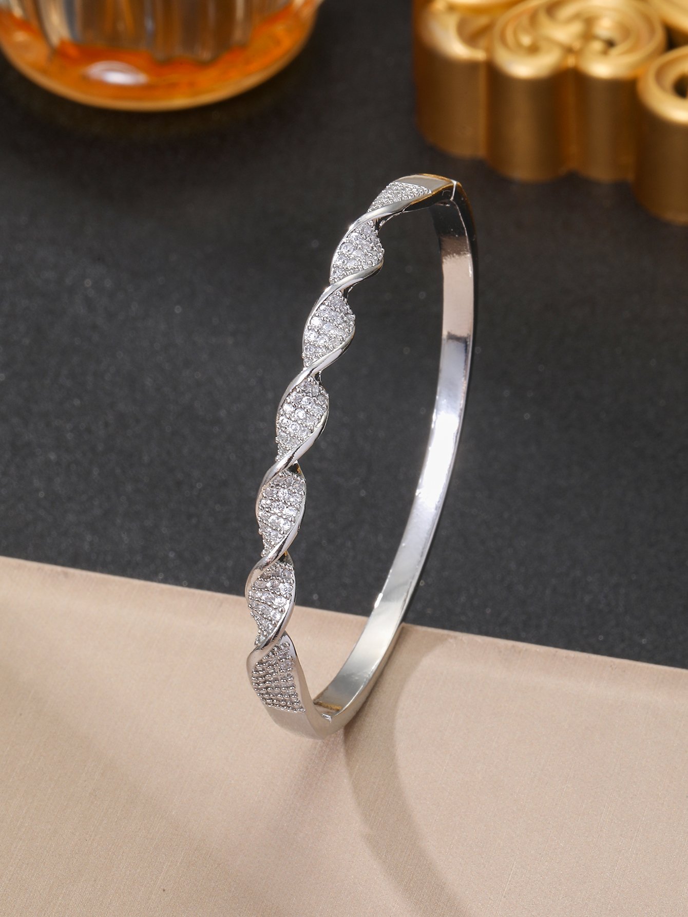 A silver twisted design ladies bracelet set with ultra-shiny cubic zirconia, perfect for parties and dinners