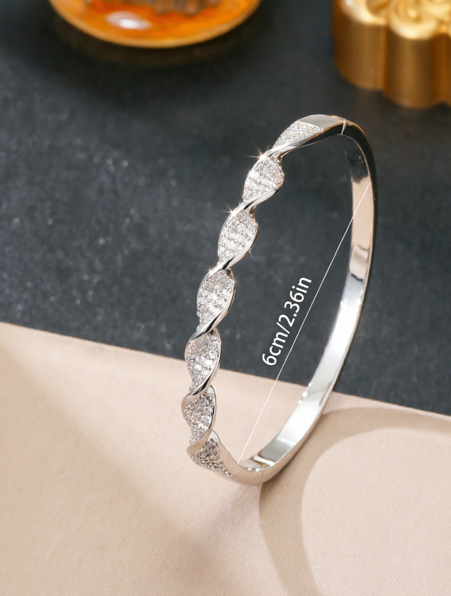A silver twisted design ladies bracelet set with ultra-shiny cubic zirconia, perfect for parties and dinners