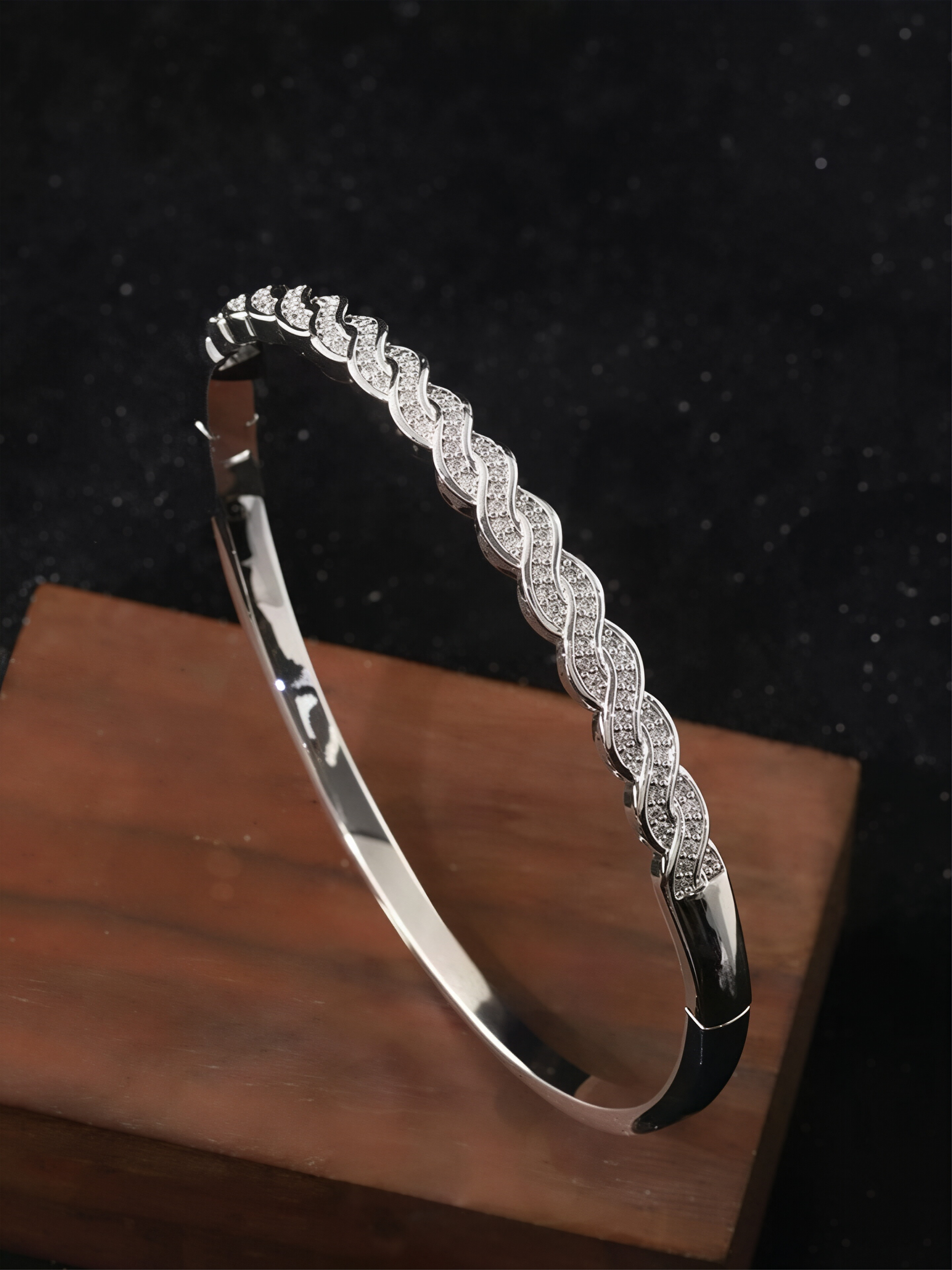 A silver twisted design ladies bracelet set with ultra-shiny cubic zirconia, perfect for parties and dinners