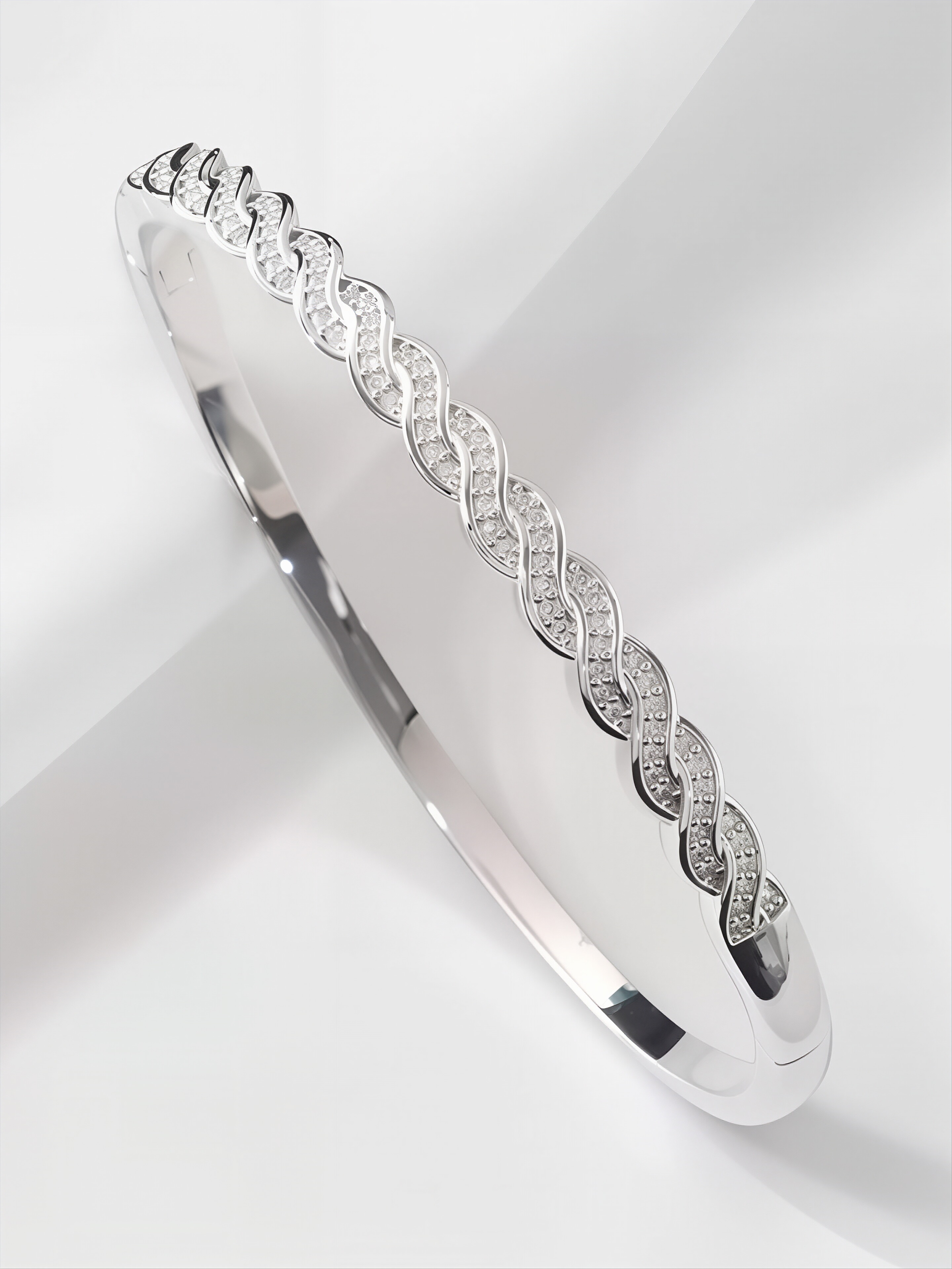 A silver twisted design ladies bracelet set with ultra-shiny cubic zirconia, perfect for parties and dinners