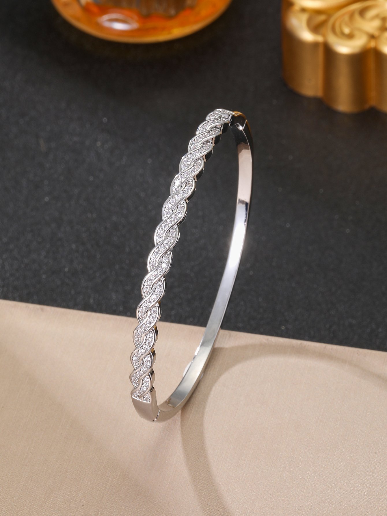 A silver twisted design ladies bracelet set with ultra-shiny cubic zirconia, perfect for parties and dinners