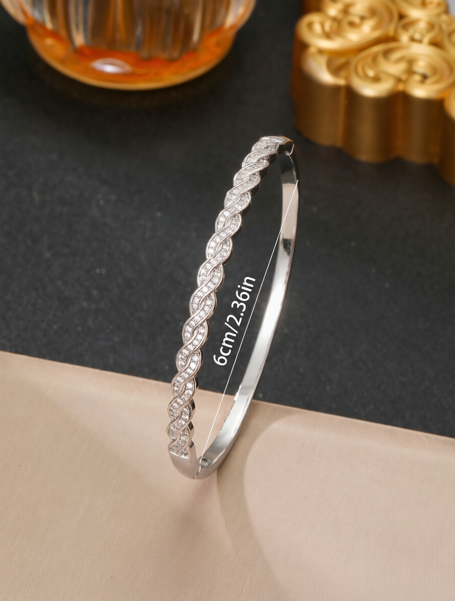 A silver twisted design ladies bracelet set with ultra-shiny cubic zirconia, perfect for parties and dinners