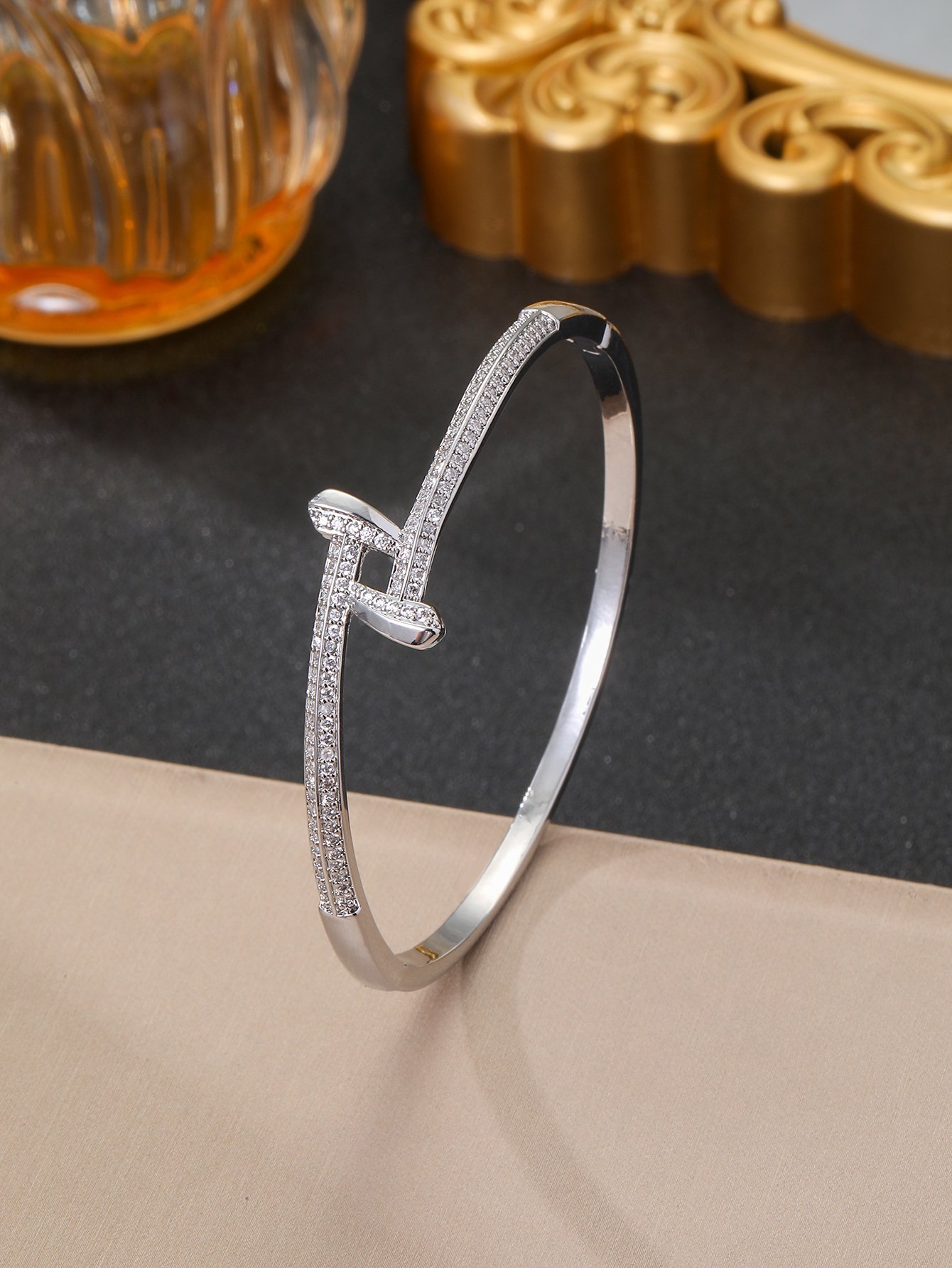 A silver stud-encrusted, ultra-shiny cubic zirconia womens bracelet, perfect for parties and dinners