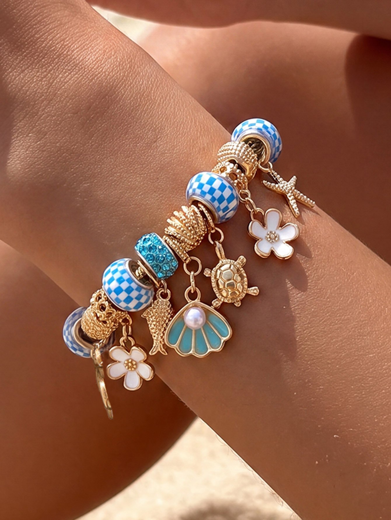 Gold-Plated Charm Bracelet with Nautical and Floral Accents