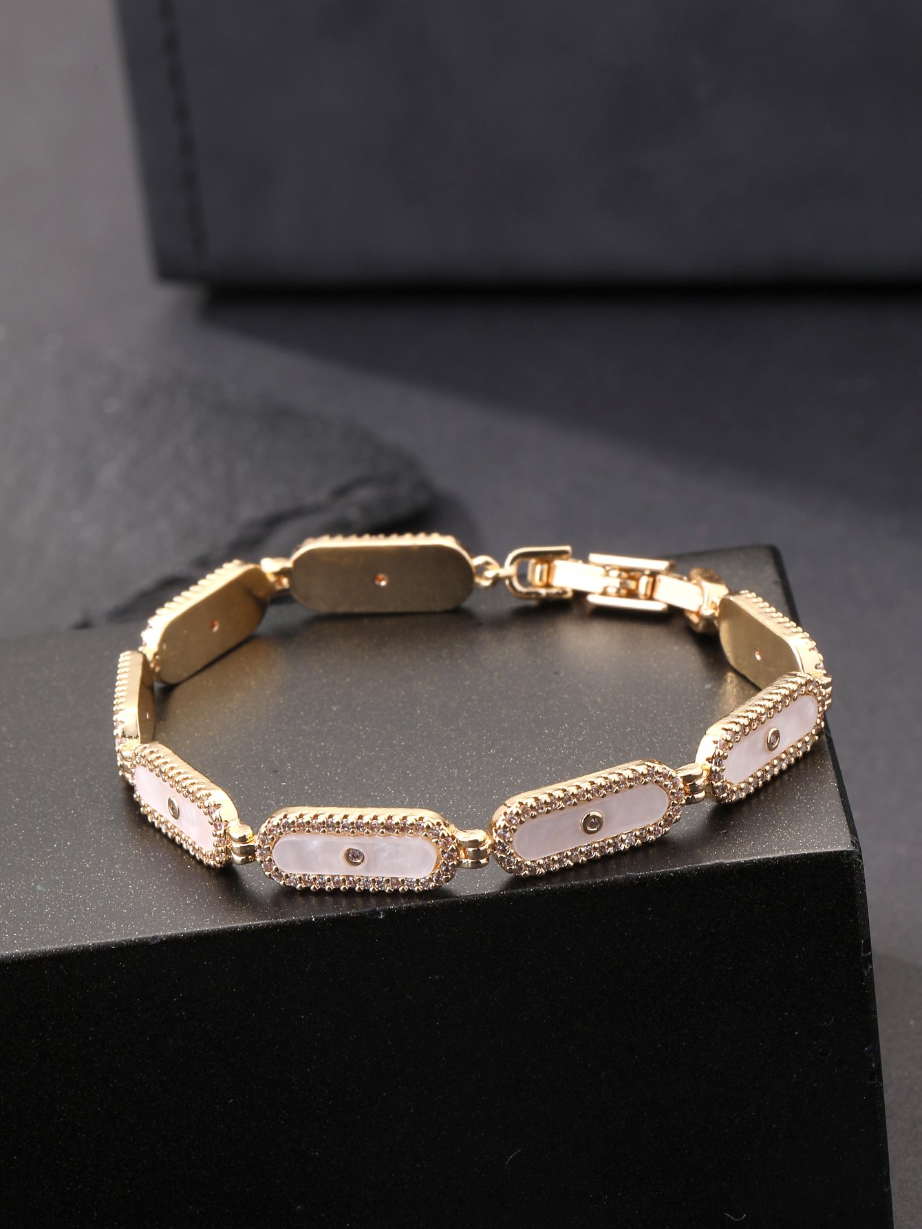 Golden oval shell bracelet set with ultra-shiny cubic zirconia, suitable for wearing to parties and dinners