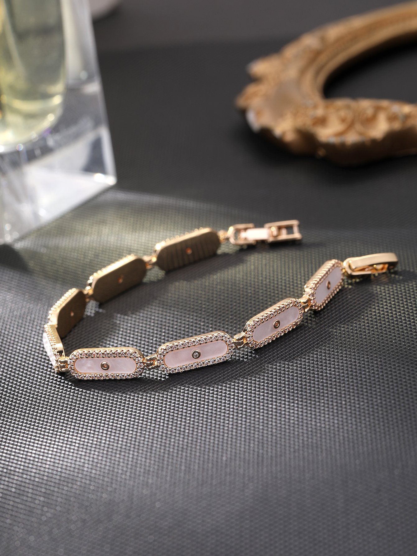 Golden oval shell bracelet set with ultra-shiny cubic zirconia, suitable for wearing to parties and dinners