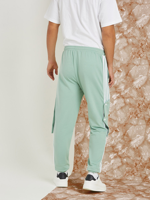 Green track pants with white stripe discount