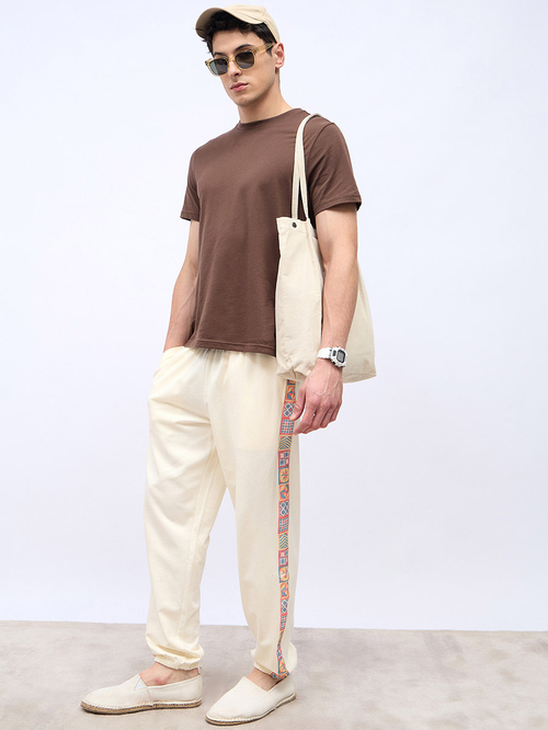 Buy Side Print Motif Relaxed Fit Joggers Cream For Men Styli UAE