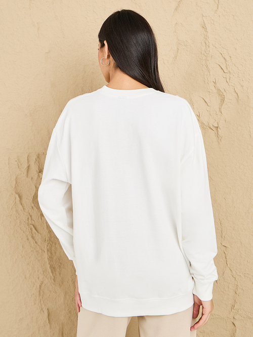 Buy Regular Fit Longline Slogan Embroidered Sweatshirt Cream For Women Styli Saudi