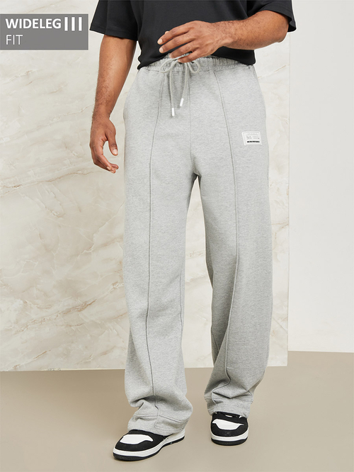 Buy Fleece Pintuck Wide Leg Joggers with Badge Detail Grey For Men Styli Saudi
