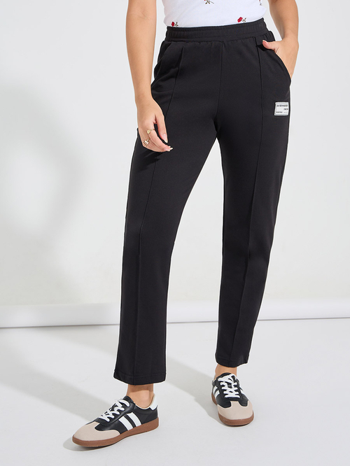 Buy High Rise Straight Leg Joggers with Badge Detail Black For Women Styli Saudi