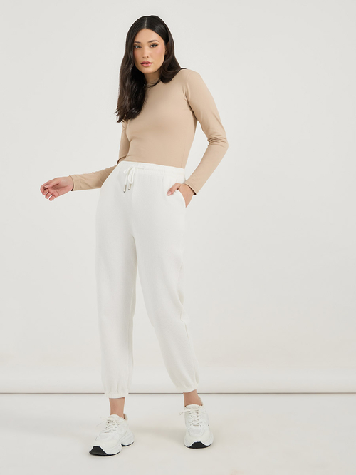 Buy High Rise Elasticated Waistband Cuffed Joggers with Drawstring Off White For Women Styli UAE